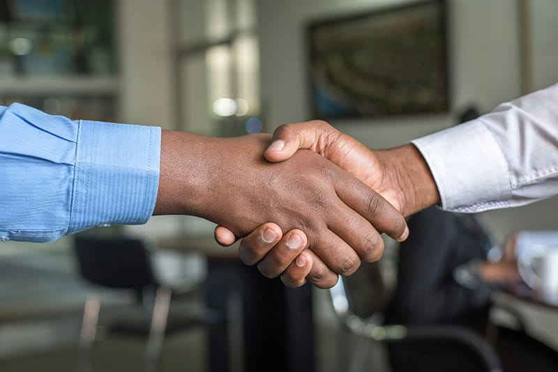 Professional handshake representing transparency